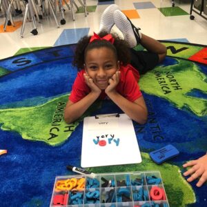 Dreamers Academy Student on Floor smiling